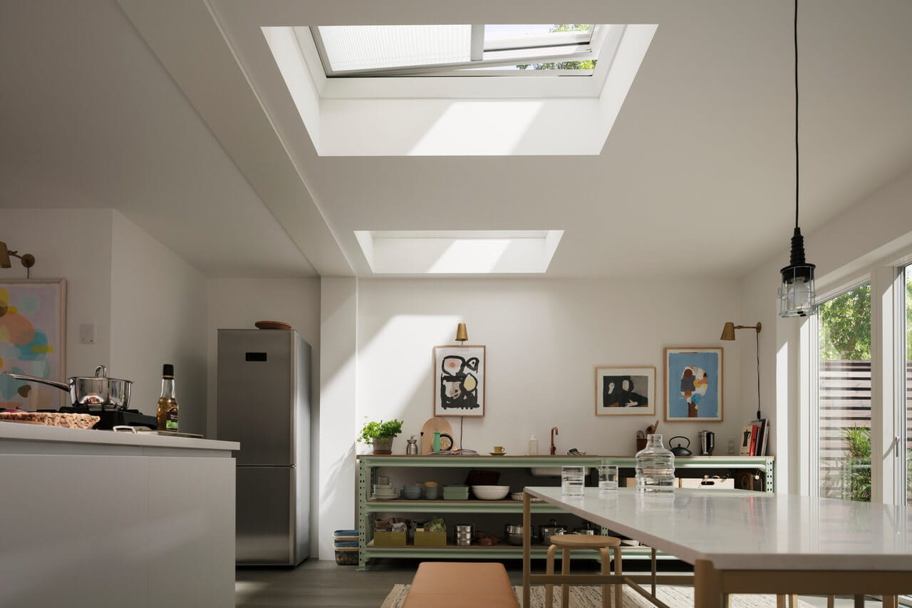 Bright modern kitchen with VELUX skylight, wooden cupboards, and terrazzo flooring.
