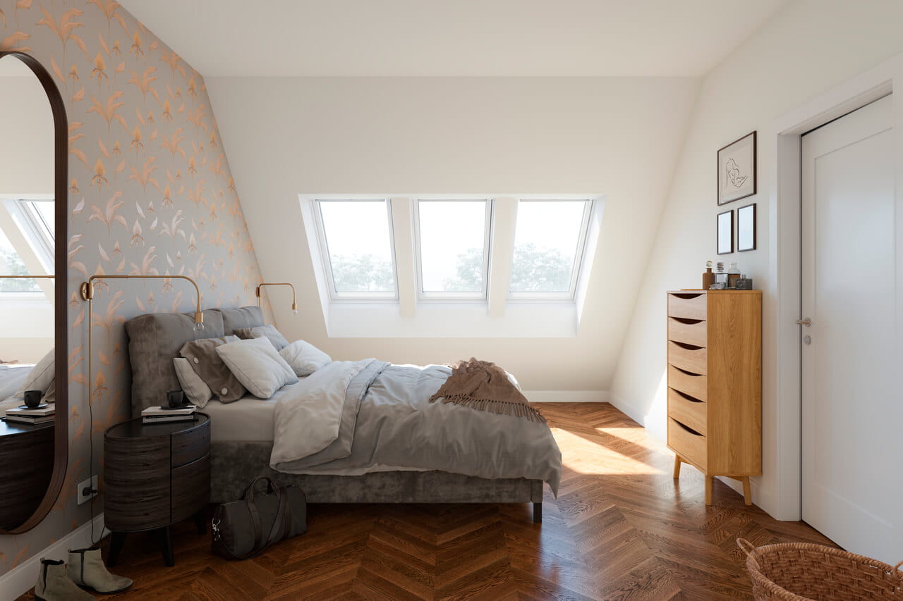 Cosy loft bedroom with plush bedding, floral wallpaper, and VELUX roof windows.