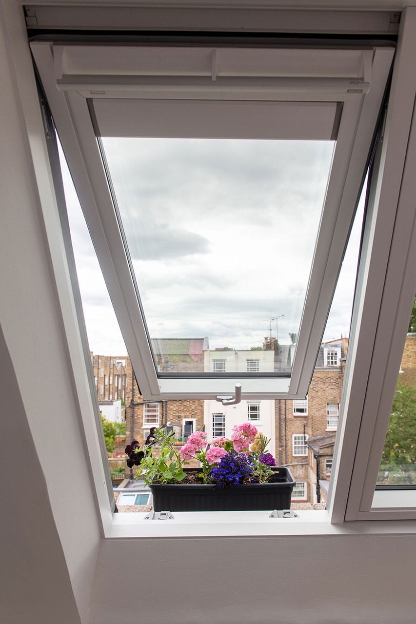 A hushed rooftop room in London-view from open roof window