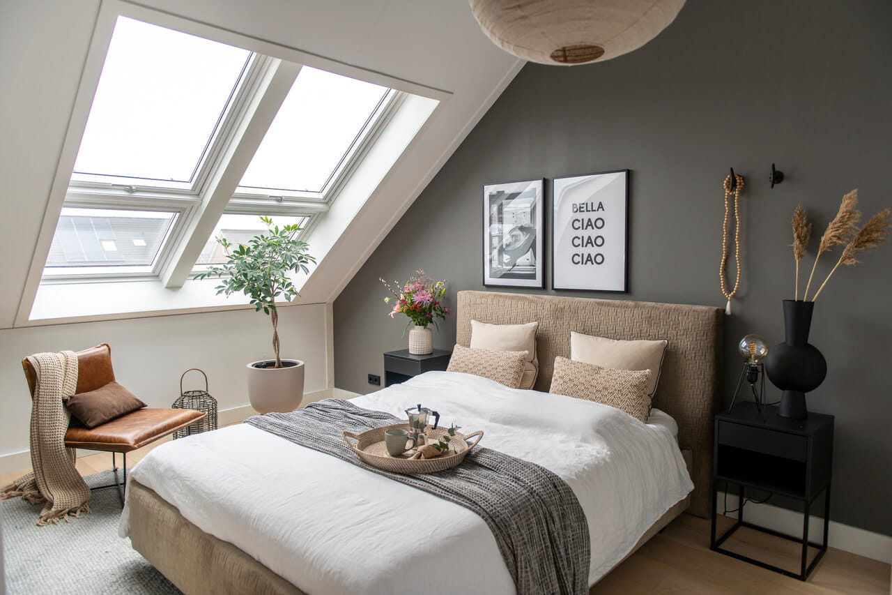 A bright bedroom with roof windows in the attic.