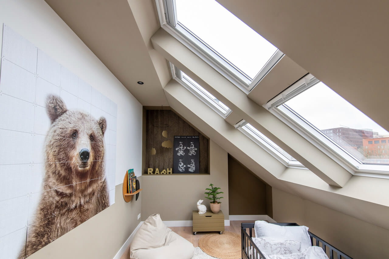 A bright room in the attic with roof windows.