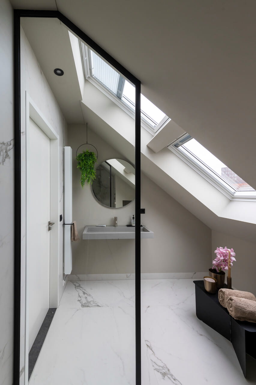 Bathroom in the attic with roof windows.