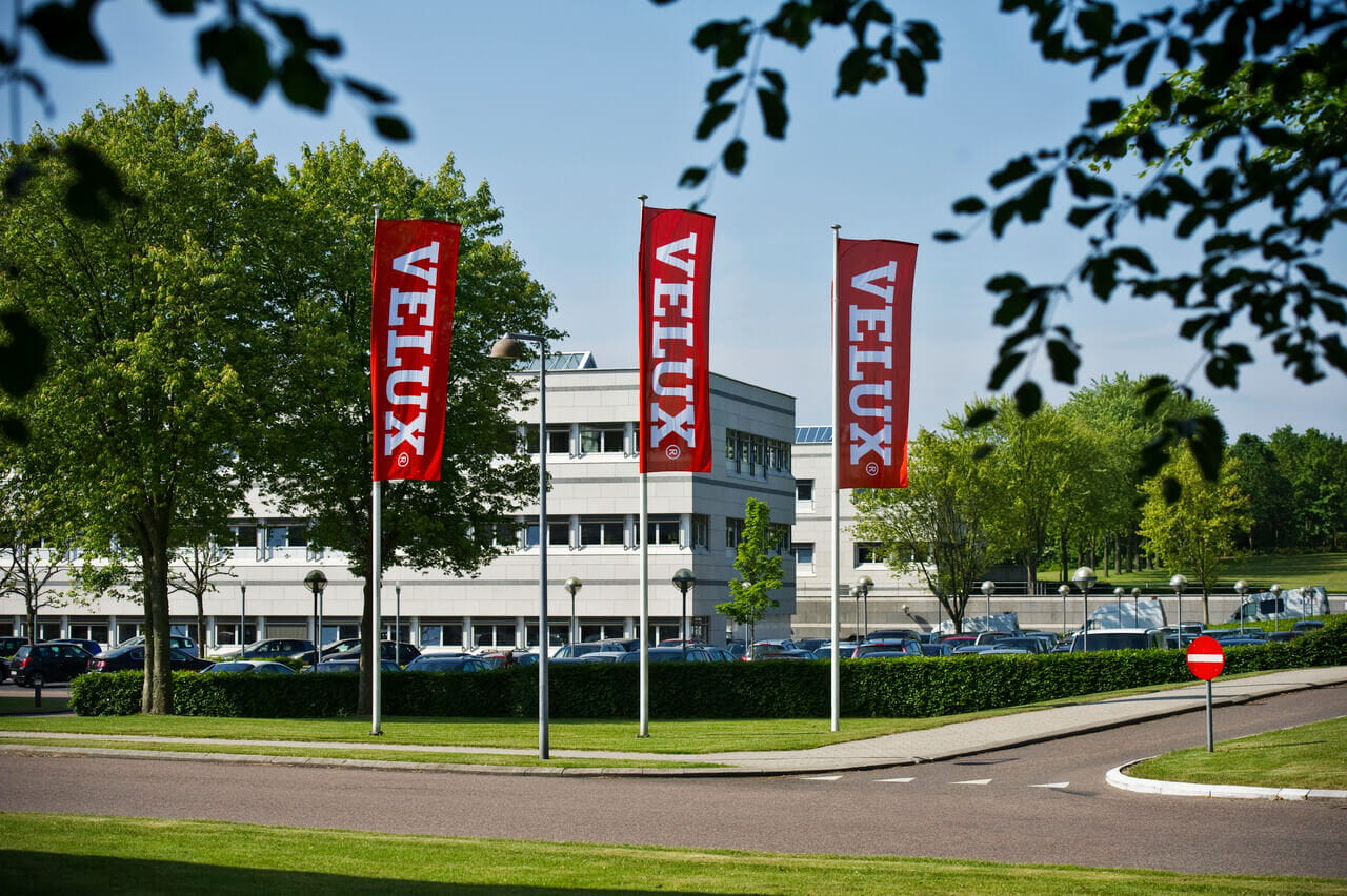 Image of three flags outside the head office of VELUX in Hoersholm