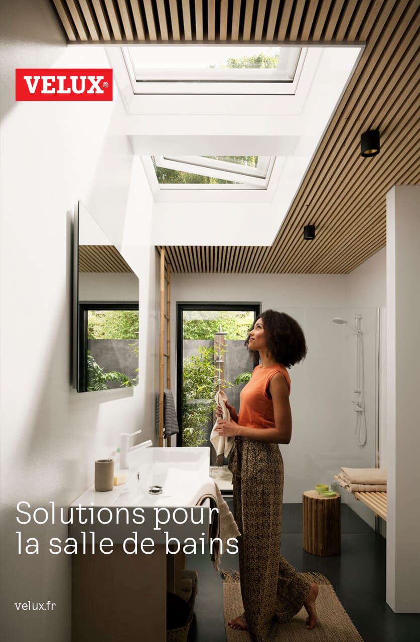 Modernes Badezimmer mit natürlichem Licht von VELUX Dachflächenfenstern und grünem Ausblick ins Freie.
