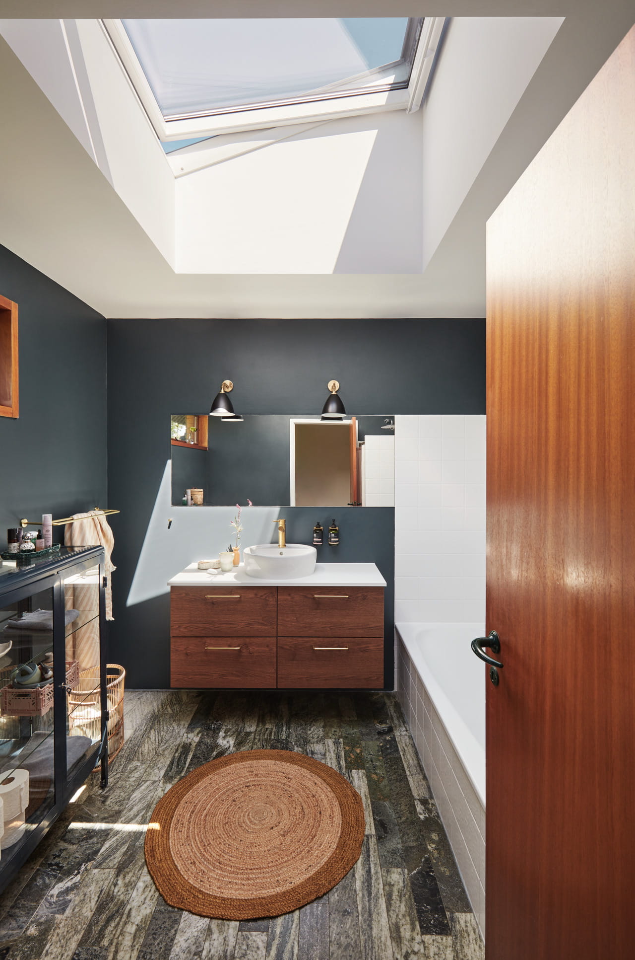 A bright bathroom with a flat roof window in the center.